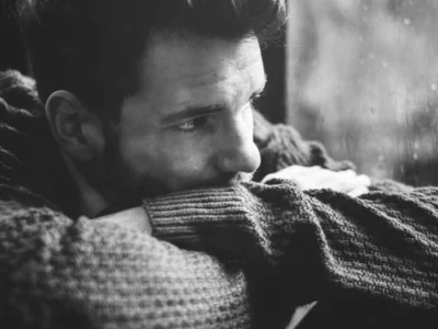 A depressed man looking out of the window